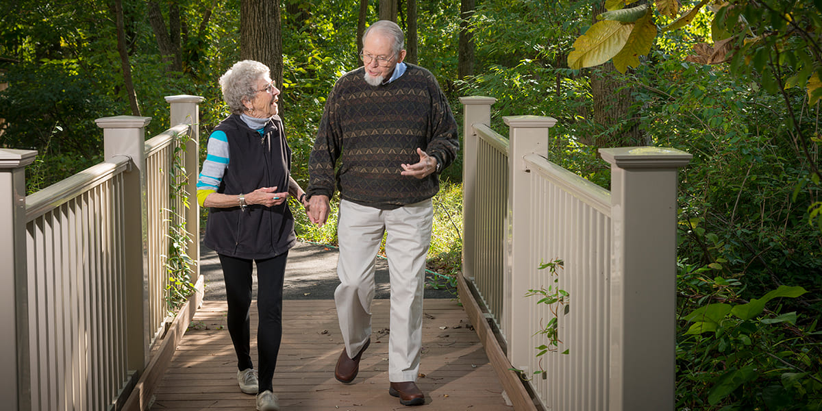 seniors walking on bridge