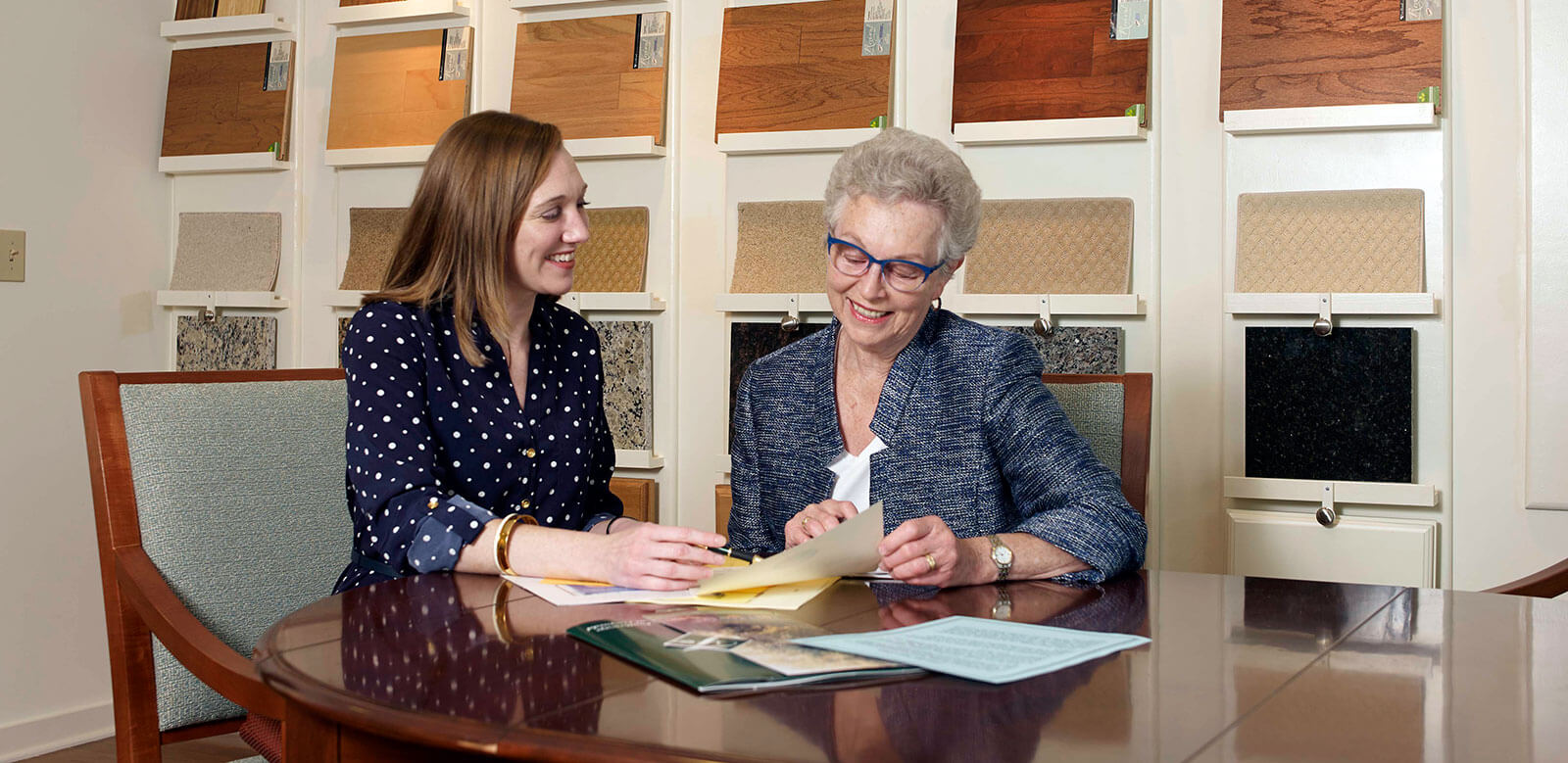 Staff and Future Resident reviewing retirement living at Foulkeways